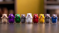 Colorful row of cute hamster figurines standing in line on wooden surface against blurred background, decorative miniature animal collection.