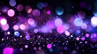 Magical glowing bokeh lights in purple, pink and blue colors against dark background create dreamy atmospheric effect with floating particles and sparkles.