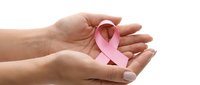 Hands gently holding pink ribbon symbol for breast cancer awareness campaign and support isolated on white background for healthcare design.