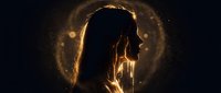 Young woman silhouette holding glowing light bulb with magical golden particles and bokeh effects on dark background for creativity and innovation concepts.