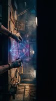 Industrial worker operating futuristic holographic interface in dark factory with atmospheric lighting and steam effects for technology concepts.