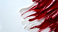 Abstract red and white paint strokes creating dynamic flowing movement on light background for modern artistic design projects.