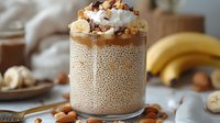 Creamy tapioca pudding topped with whipped cream, granola, and nuts in a glass, styled with fresh bananas and ingredients for dessert preparation.
