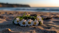 Delicate daisy flower crown lying on golden beach sand at sunset, with blurred ocean waves and warm evening light creating romantic coastal atmosphere.