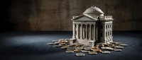 Classical bank building model surrounded by scattered coins on dark surface representing financial institution collapse or economic crisis.