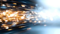Abstract golden light trails and bokeh effects on blue background create dynamic motion and energy for technology and innovation concepts.