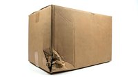 Damaged brown cardboard shipping box with torn corner on white background isolated for packaging and delivery concepts.