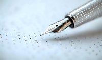 Elegant fountain pen nib with textured metallic barrel in macro view against soft white background, showing fine craftsmanship and writing precision.