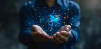 Hands cupping glowing blue digital house hologram with sparkles and particles, representing smart home technology and real estate innovation in dark background.