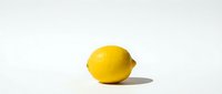 Fresh yellow lemon fruit isolated on white background with soft shadow. Citrus ingredient for cooking, beverages and healthy nutrition concepts.