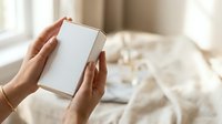 Woman holding blank white box with copy space for product packaging mockup, branding, or retail display purposes.