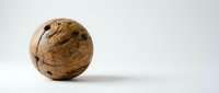Whole walnut with natural brown shell and visible crack lines on clean white background, isolated organic nut for healthy eating and nutrition concepts.