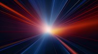 Dramatic light burst with red and blue rays radiating from bright center point against dark background creates dynamic perspective and motion effect.