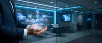 Businessman holding holographic digital interface with data analytics in modern office environment showcasing future technology and business innovation concepts.