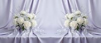 Elegant white rose bridal bouquets with silver ribbon on luxurious purple satin fabric backdrop for wedding ceremony and romantic celebration decor.