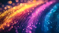 Vibrant abstract background with glowing particles and light trails in orange, pink, and blue colors creating dynamic motion effect with bokeh and sparkles.