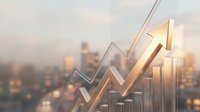Golden arrow pointing upward with rising bar charts against blurred city skyline at sunset, representing business growth, financial success and market trends.