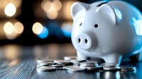 White ceramic piggy bank surrounded by scattered coins with warm bokeh lights creating financial savings and investment concept for personal finance planning.