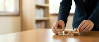 Business professional arranging wooden blocks with star ratings on office desk for customer satisfaction and quality service evaluation concepts.