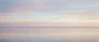 Serene dawn seascape with soft pastel sky reflecting on calm water, conveying tranquility and peaceful morning atmosphere for wellness and meditation content.