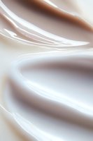 Flowing abstract waves in soft brown and white tones create gentle curved lines and smooth gradients, suitable for luxury branding and modern minimalist designs.