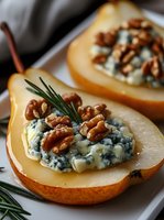 Roasted pear halves stuffed with creamy blue cheese and crunchy walnuts, garnished with fresh rosemary for elegant appetizer or gourmet dessert presentation.