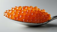 Fresh orange salmon caviar pearls on silver spoon against light background, luxury seafood delicacy close-up macro photography showing texture and shine.