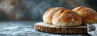Fresh homemade burger buns with sesame seeds on rustic wooden board against dark background, selective focus with copy space for menu design.
