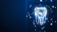 Glowing tooth hologram with blue light effects on dark background for dental care and oral health technology concepts in modern healthcare design.