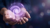 Hands holding glowing purple spiral energy orb with magical light particles, representing innovation, technology, power, and digital transformation concepts for business and science.