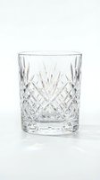 Crystal cut glass tumbler with diamond pattern isolated on white background for luxury dining and beverage service.