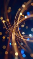 Abstract golden light trails with bokeh effects creating dynamic flowing curves on dark blue background for technology and digital concepts.