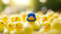 Cute blue and yellow rubber ducks in a group with shallow depth of field, perfect for children's products, nursery decor, toy marketing, and playful design projects.
