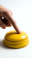Caucasian male hand pressing bright yellow buzzer button on white background, ready for game shows, quizzes, and interactive events.