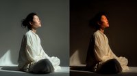 Young Asian woman in white shirt sitting peacefully with eyes closed in natural sunlight, meditation and mindfulness concept for wellness content.
