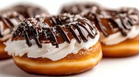 Glazed donuts with white icing and chocolate drizzle on top, sweet bakery treats for dessert and cafe menu designs.