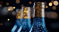 Close-up of wine bottle neck with golden bokeh lights in background creating festive atmosphere. Blue tinted glass reflects ambient lighting in dark setting.