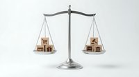 Professional balance scale weighing miniature wooden houses representing real estate market comparison and property investment decisions on white background.