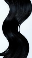 Luxurious black hair wave on white background, showing smooth, shiny texture and natural flow. For beauty and hair care advertising.