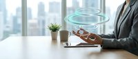 Businessman in gray suit holding wooden tablet with glowing digital rings floating above, modern office with city skyline window, representing technology innovation and digital transformation for business solutions.