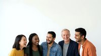 Diverse group of five men and women of mixed ethnicities smiling together against white background, representing teamwork, diversity, and professional collaboration for corporate, business, and community projects.