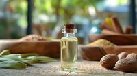 Small glass bottle of almond oil with cork stopper surrounded by raw almonds and bay leaves on rustic surface, natural light background.