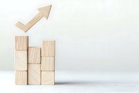 Wooden blocks stacked in ascending formation with upward arrow symbolizing growth, success, and business development on white background.
