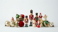 Festive Christmas decoration collection with nutcracker soldiers, Santa figures, ornament balls and holiday toys arranged on white background for seasonal design.