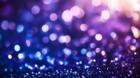 Magical bokeh lights creating dreamy purple and blue background with glowing defocused circles and sparkles. Abstract festive backdrop for celebrations.