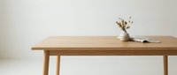 Wooden table with natural finish and minimalist decor featuring dried flowers in ceramic vase, suitable for interior design, home staging, and furniture marketing.