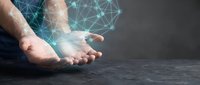 Caucasian male hands holding glowing digital network mesh structure against dark background, representing technology, connectivity, data transfer, and innovation concepts.