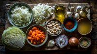 Fresh cooking ingredients arranged on rustic wooden surface with vegetables, legumes, spices, and oils for homemade meal preparation.