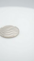 Clear petri dish with wavy gel or cream texture inside, isolated on white background, suitable for cosmetics, skincare, laboratory, and product packaging design use.