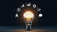 Glowing light bulb with brain filament surrounded by business icons on dark background representing innovation, creativity and entrepreneurship concepts.